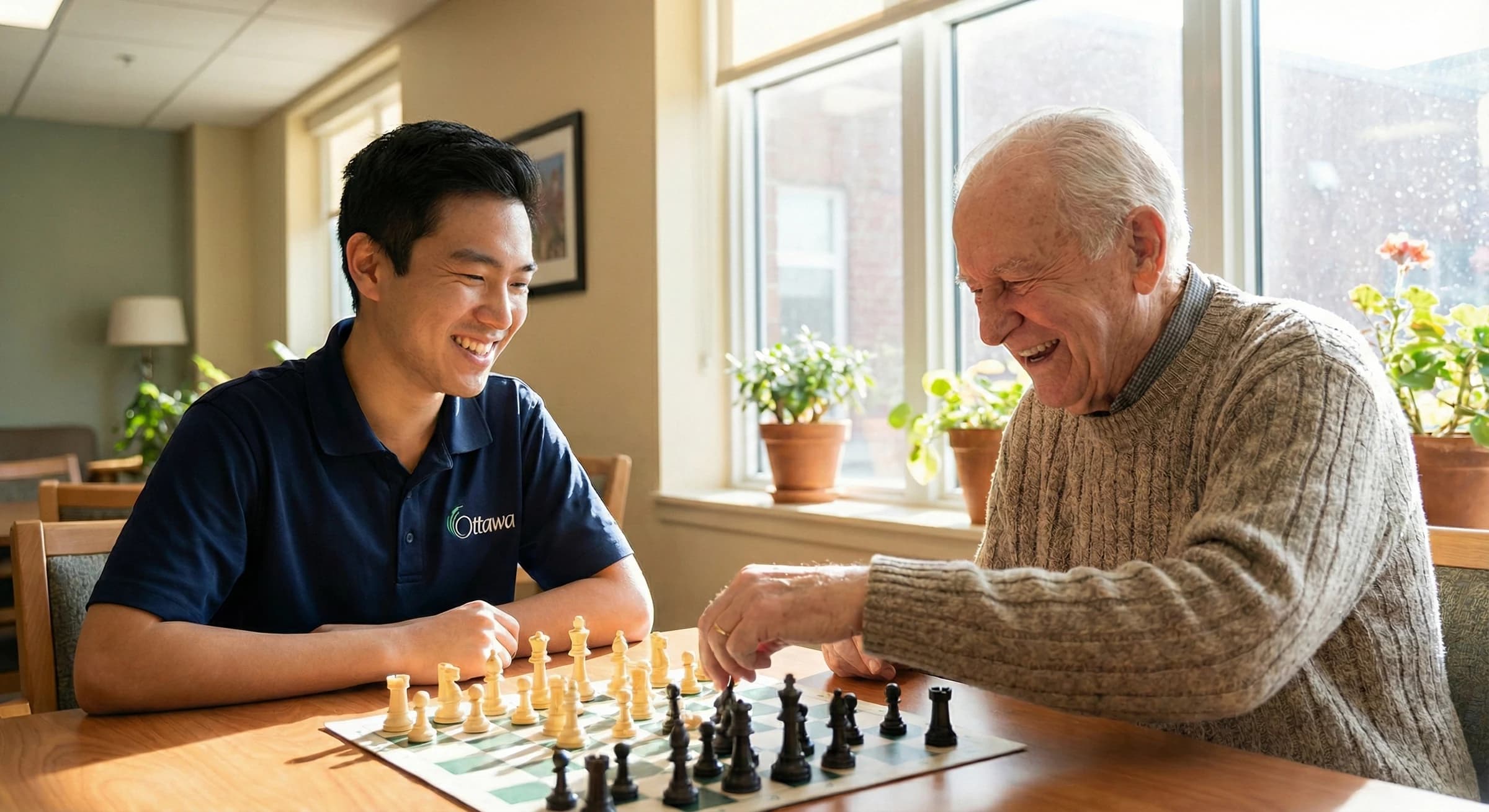 A younger and an older man playing chess together at a community centre